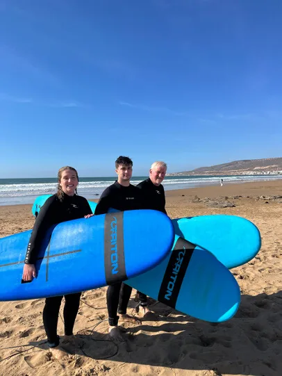 Friends with surfboards in Morocco