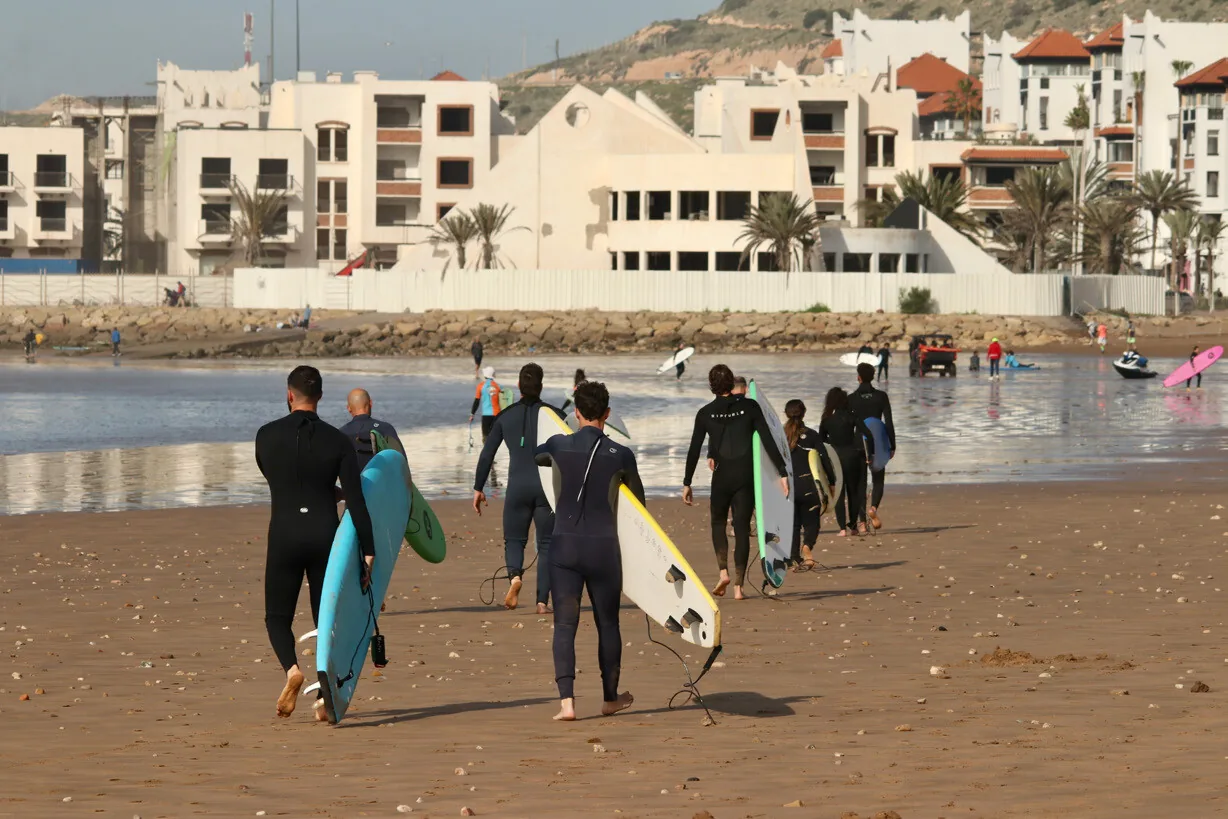 Surf group walking along the beach in Tamraght